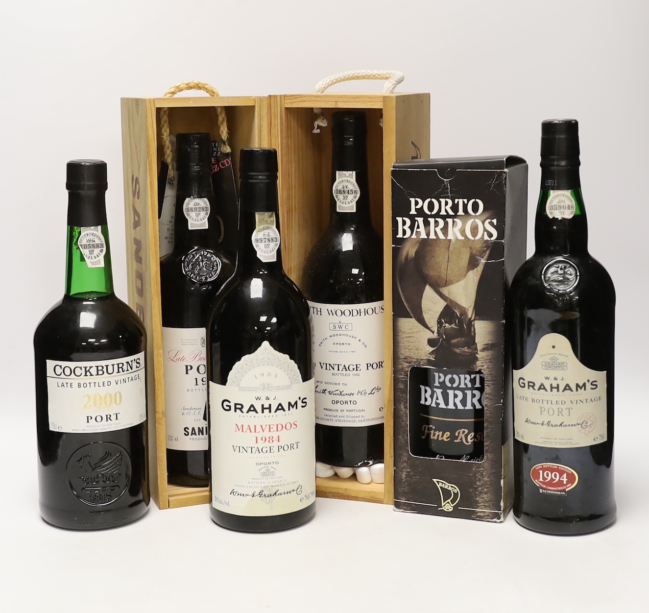 Six bottles of port, including Graham’s Malvedos 1984 vintage, Graham’s LBV 1994, Cockburn’s LBV 2000, Sandeman LBV 1986, Smith Woodhouse 1980 vintage and Porto Barros Fine Reserve.